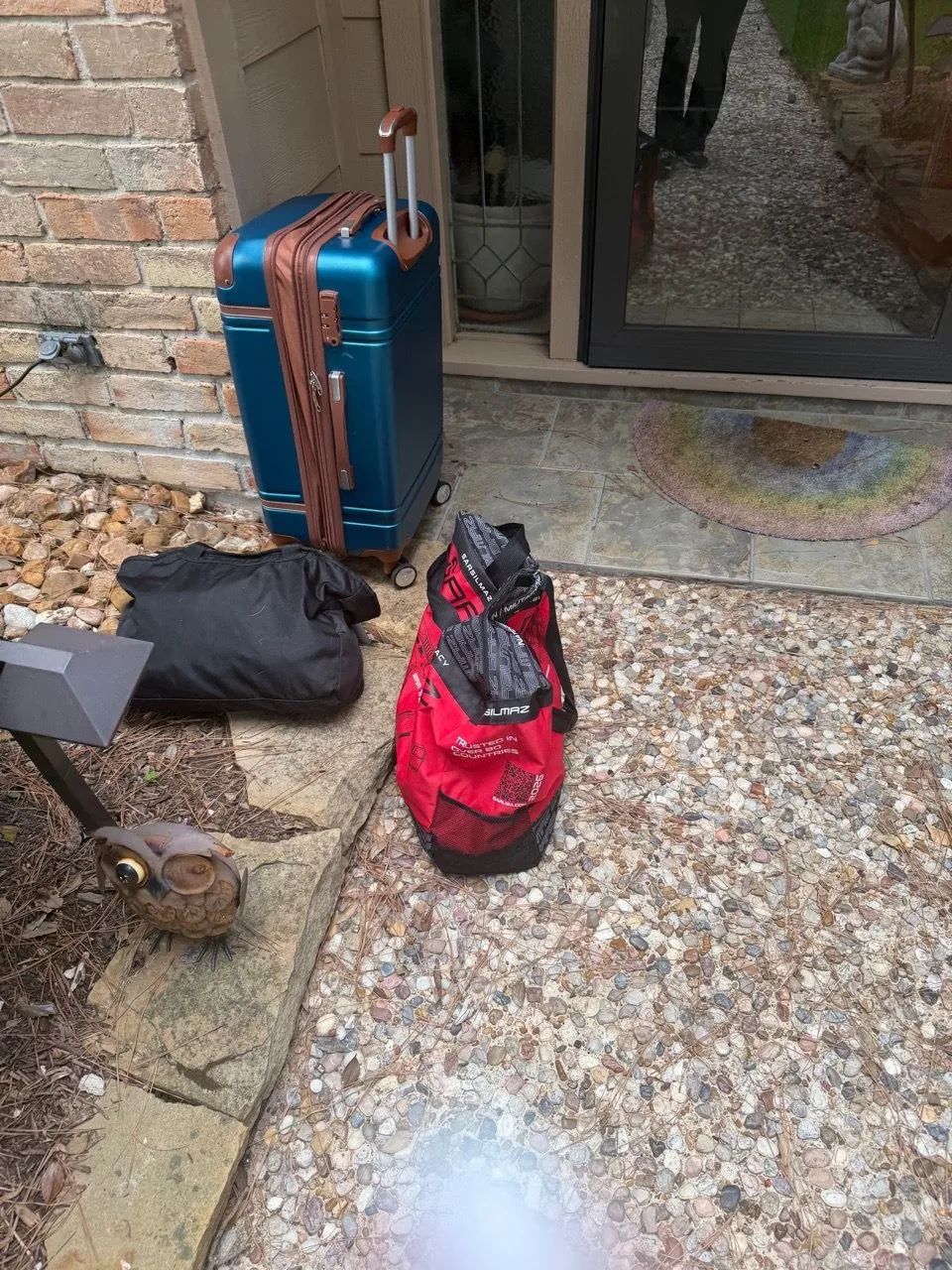Rolling case and equipment bags loaded on the driveway before an in-home appointment