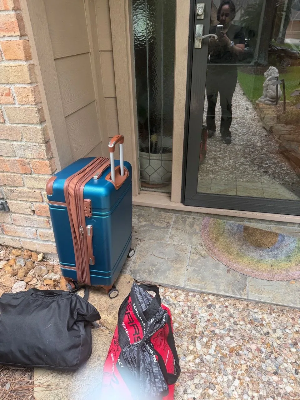 Massage table and supply bags waiting at a client's front door before an appointment