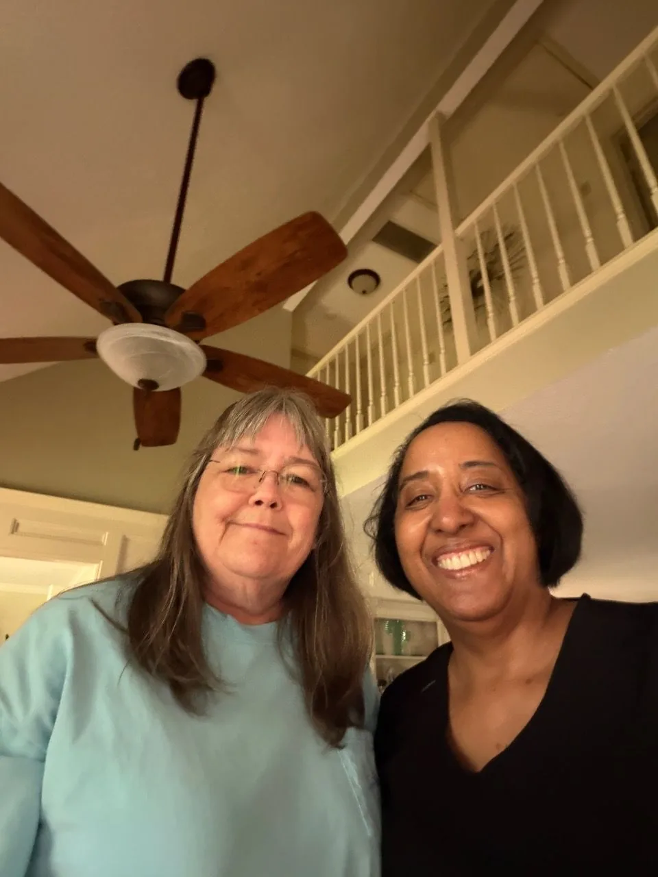 Nina standing with a longtime client in her home after a massage